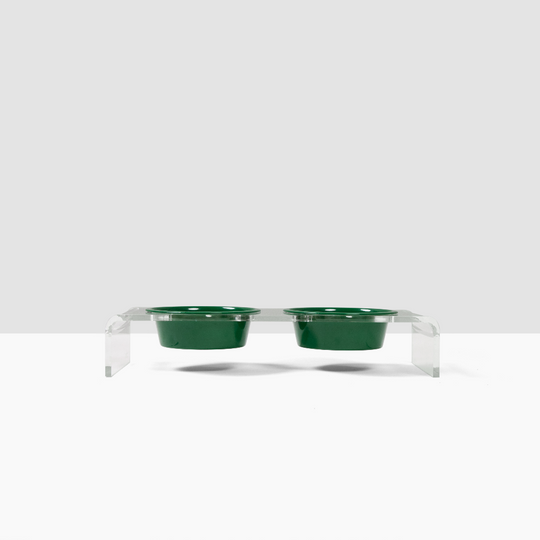 Two green bowls on top of a acrylic clear stand