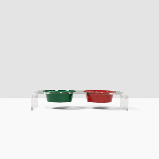 A green and red bowls on a clear stand